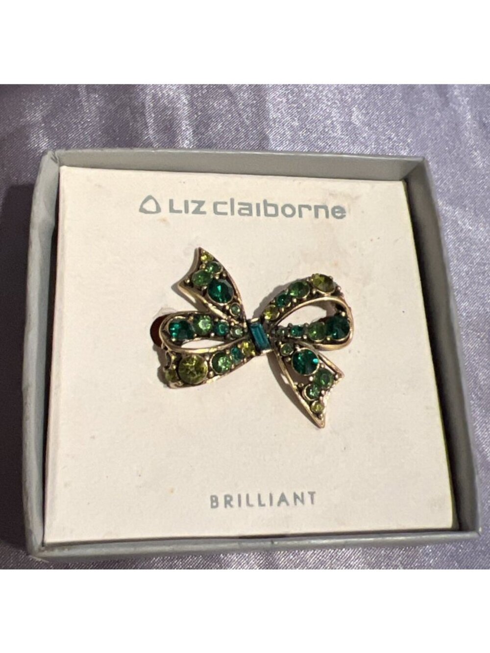 1970s New Signed Liz Claiborne Open Work Green Rhinestone Bow Brooch Gold Tone